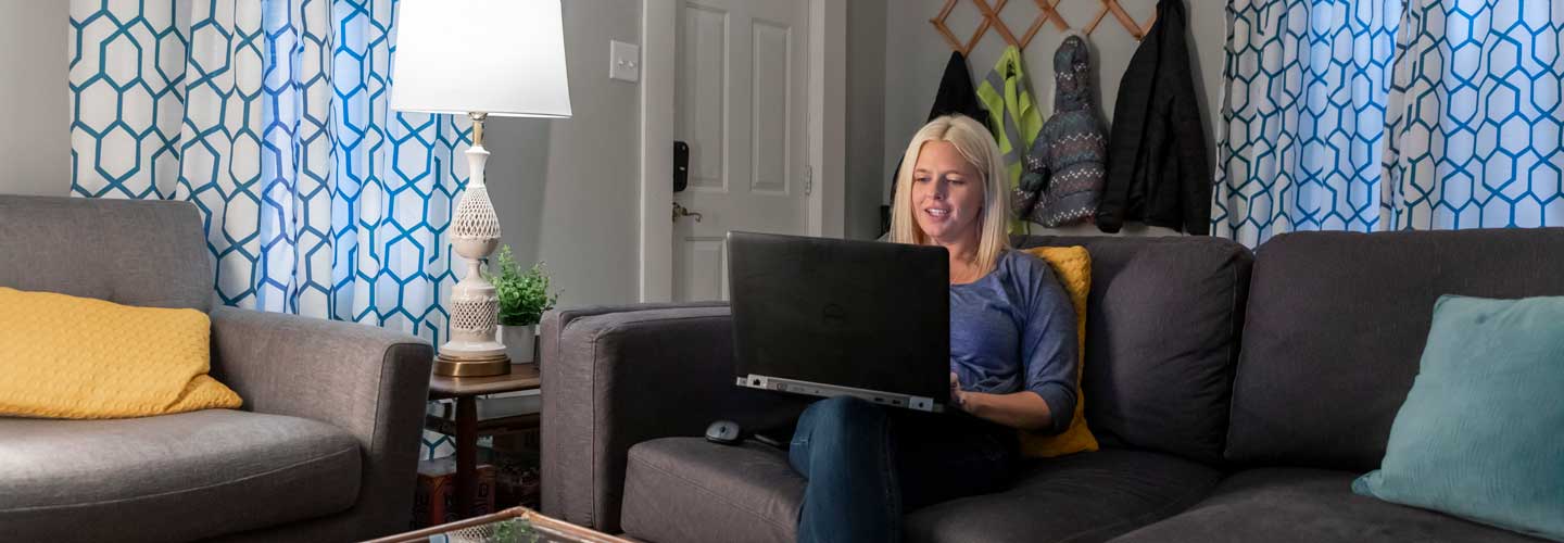 Adult student working on a laptop at home